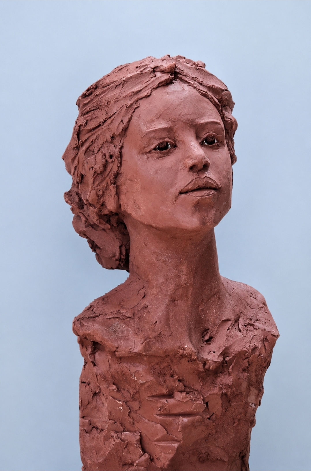 Terracotta bust — youthful figure, soft gaze